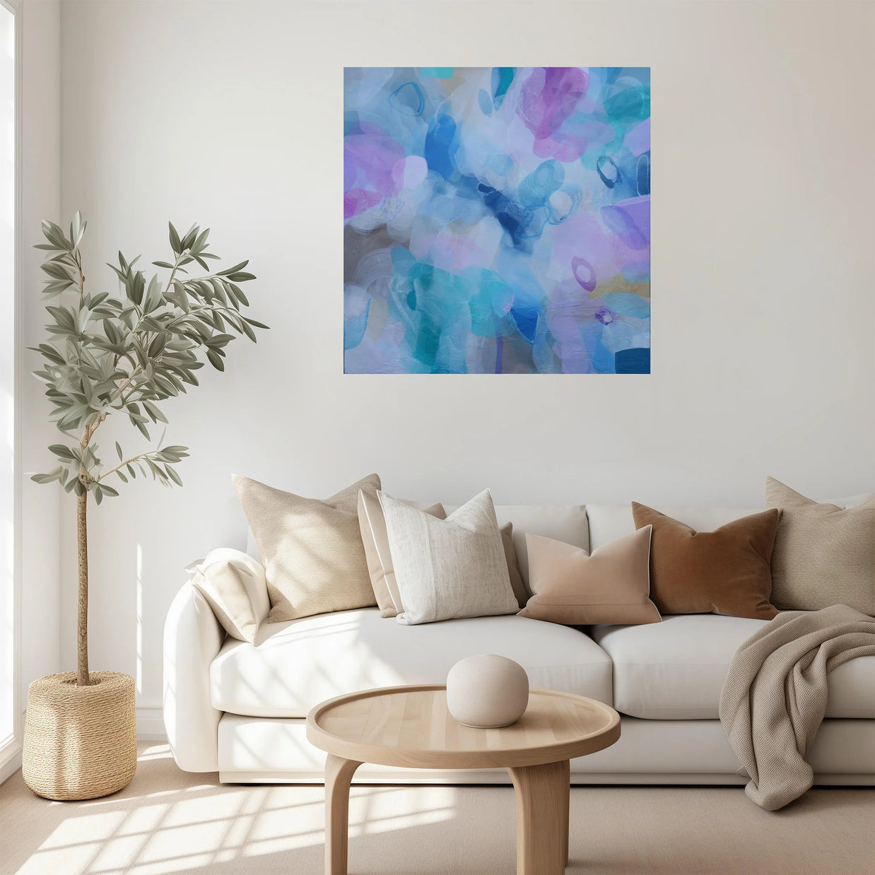 Modern living room with a white sofa, coffee table, and abstract painting on the wall.
