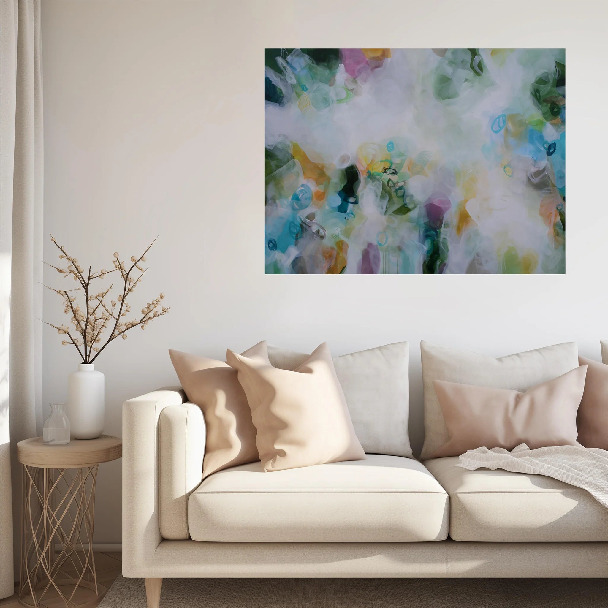 green white multicoloured abstract painting haning above cream sofa