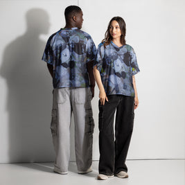 Two people wearing matching patterned shirts and pants against a white background