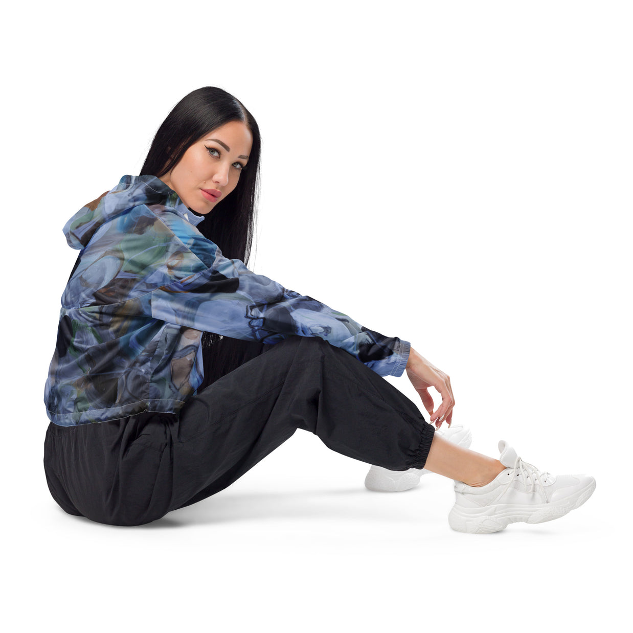 woman wearing black, white grey and green all over print croppsed windbreaker