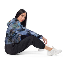woman wearing black, white grey and green all over print croppsed windbreaker