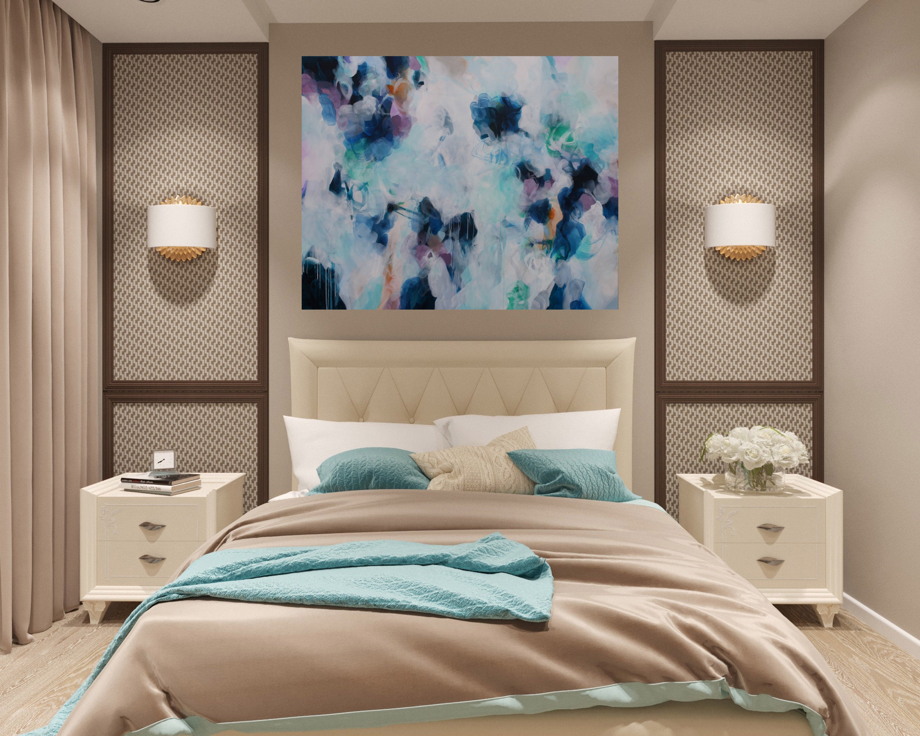 Modern bedroom with abstract art, beige headboard, and nightstands.