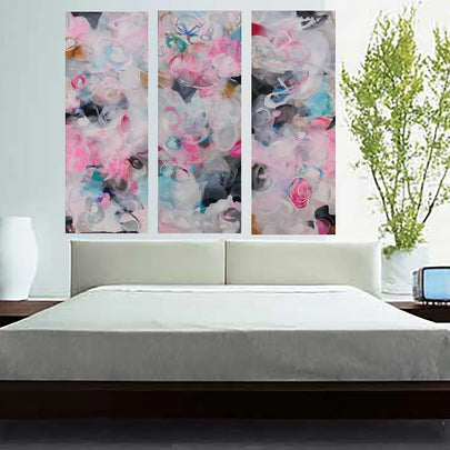 Pink, blue, white, grey, black three panel abstract painting hanging above bed 