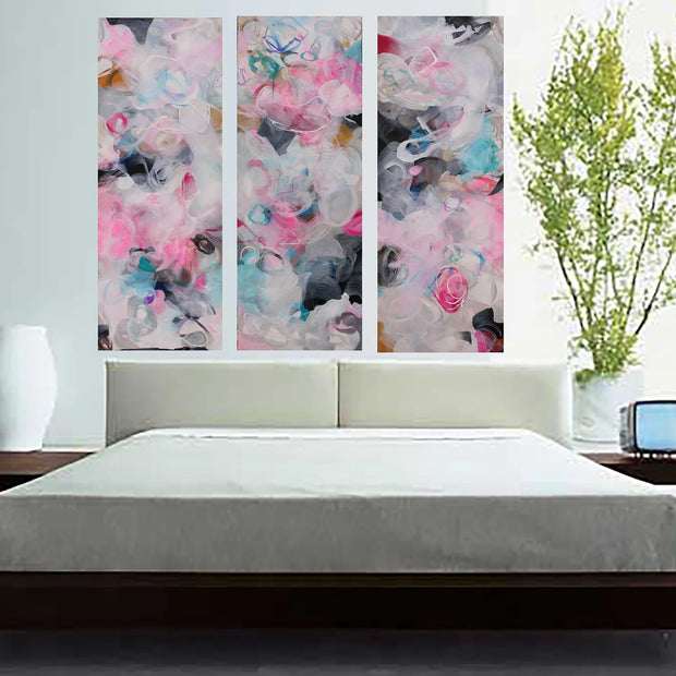 Pink, blue, white, grey, black three panel abstract painting hanging above bed 