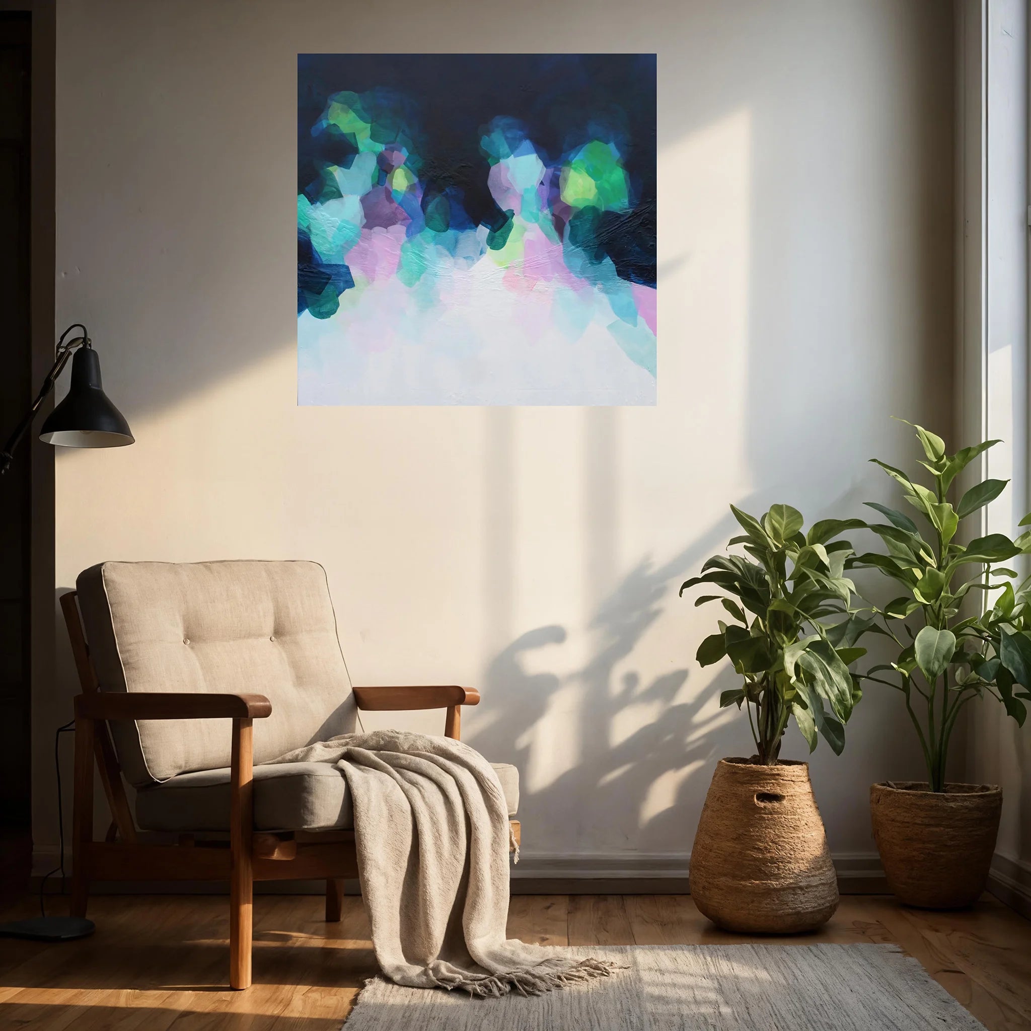 Living room with a colorful abstract painting on the wall, a chair with a blanket, and two potted plants.