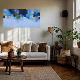 Living room with a white sofa, wooden coffee table, and abstract art on the wall.
