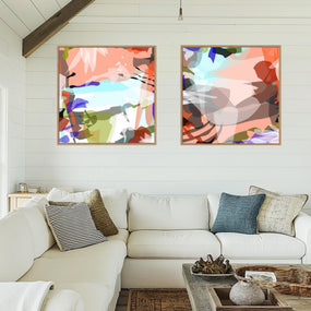 Living room with a white sofa, abstract art on the wall, and decorative items.