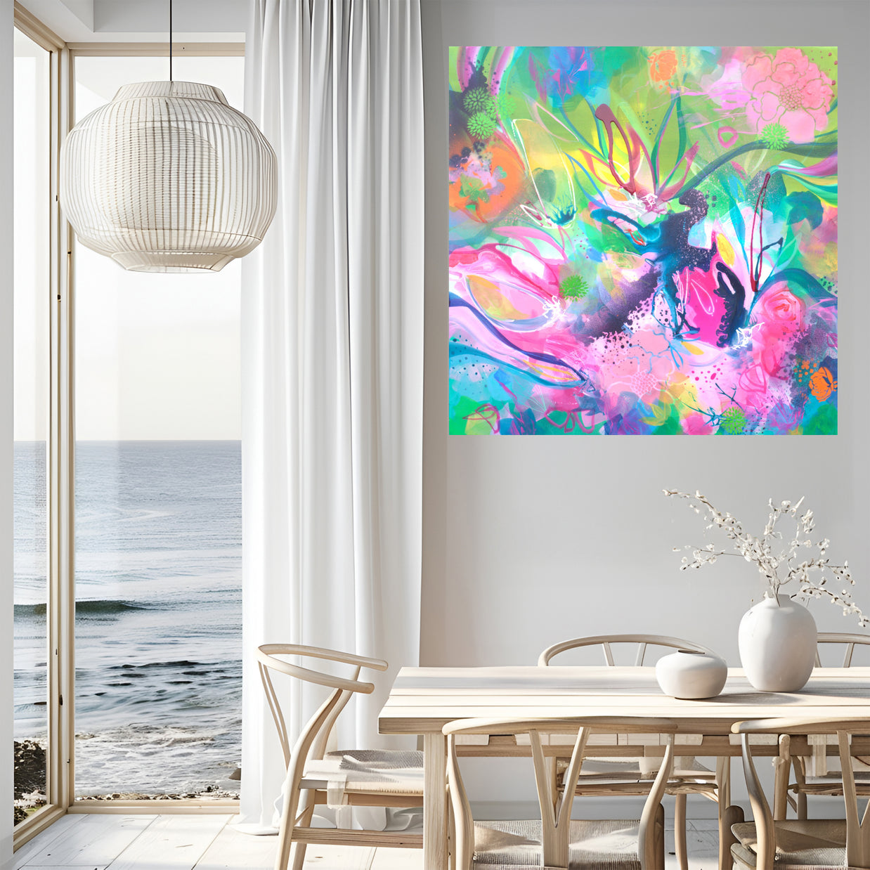 Modern interior with a colorful abstract painting on the wall, a dining table, and chairs by a large window with a view of the ocean.