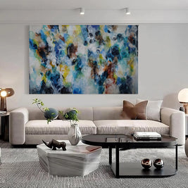 Modern living room with a colorful abstract painting above a sofa.