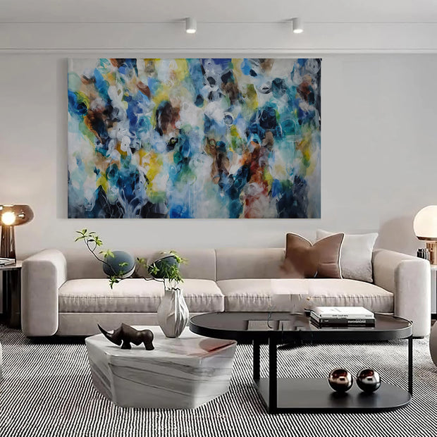 Modern living room with a colorful abstract painting above a sofa.