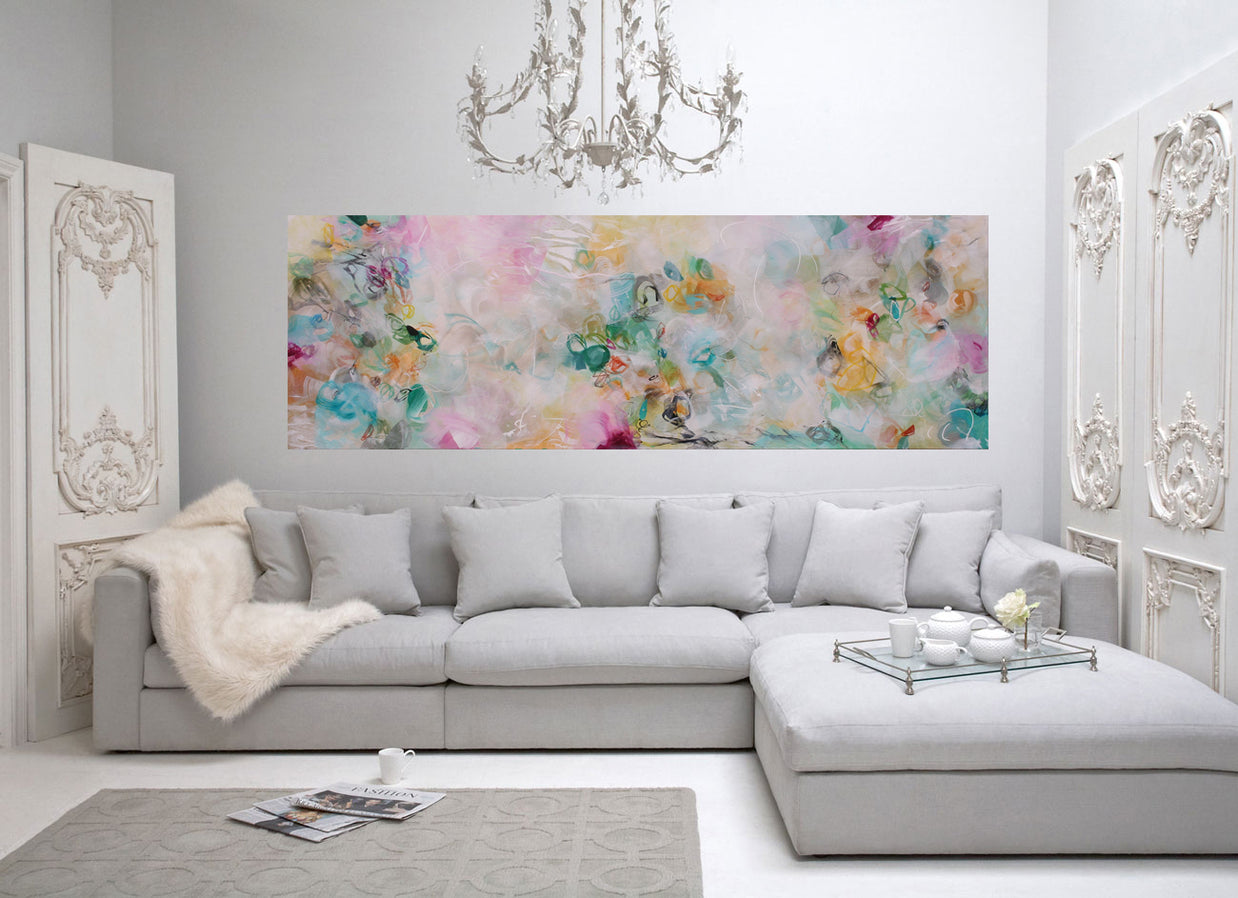 Living room with a gray sectional sofa, floral artwork, and decorative elements.