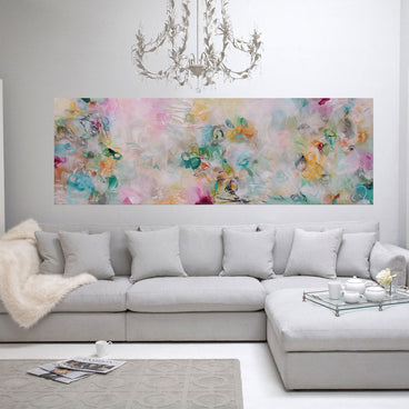 Living room with a gray sectional sofa, floral artwork, and decorative elements.