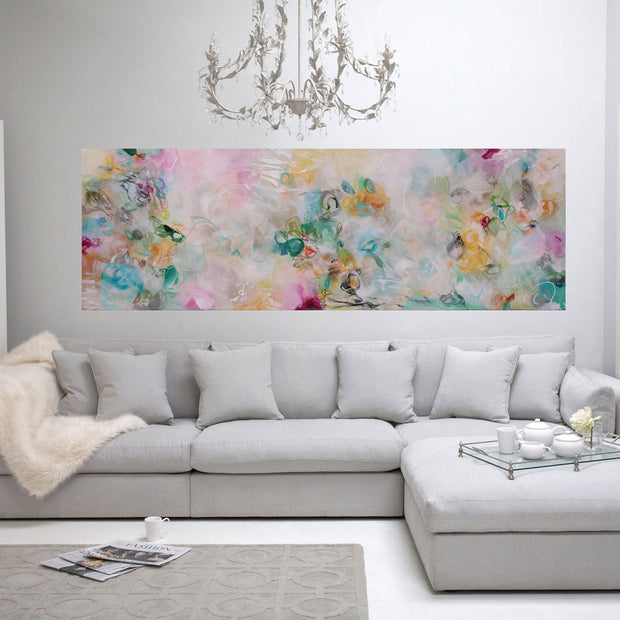 Living room with a gray sectional sofa, floral artwork, and decorative elements.