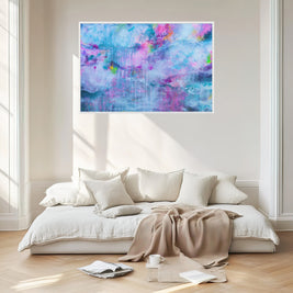 Modern bedroom with a colorful abstract painting above a bed.