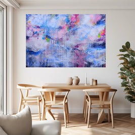 Dining room with a wooden table and chairs, and a colorful abstract painting on the wall.