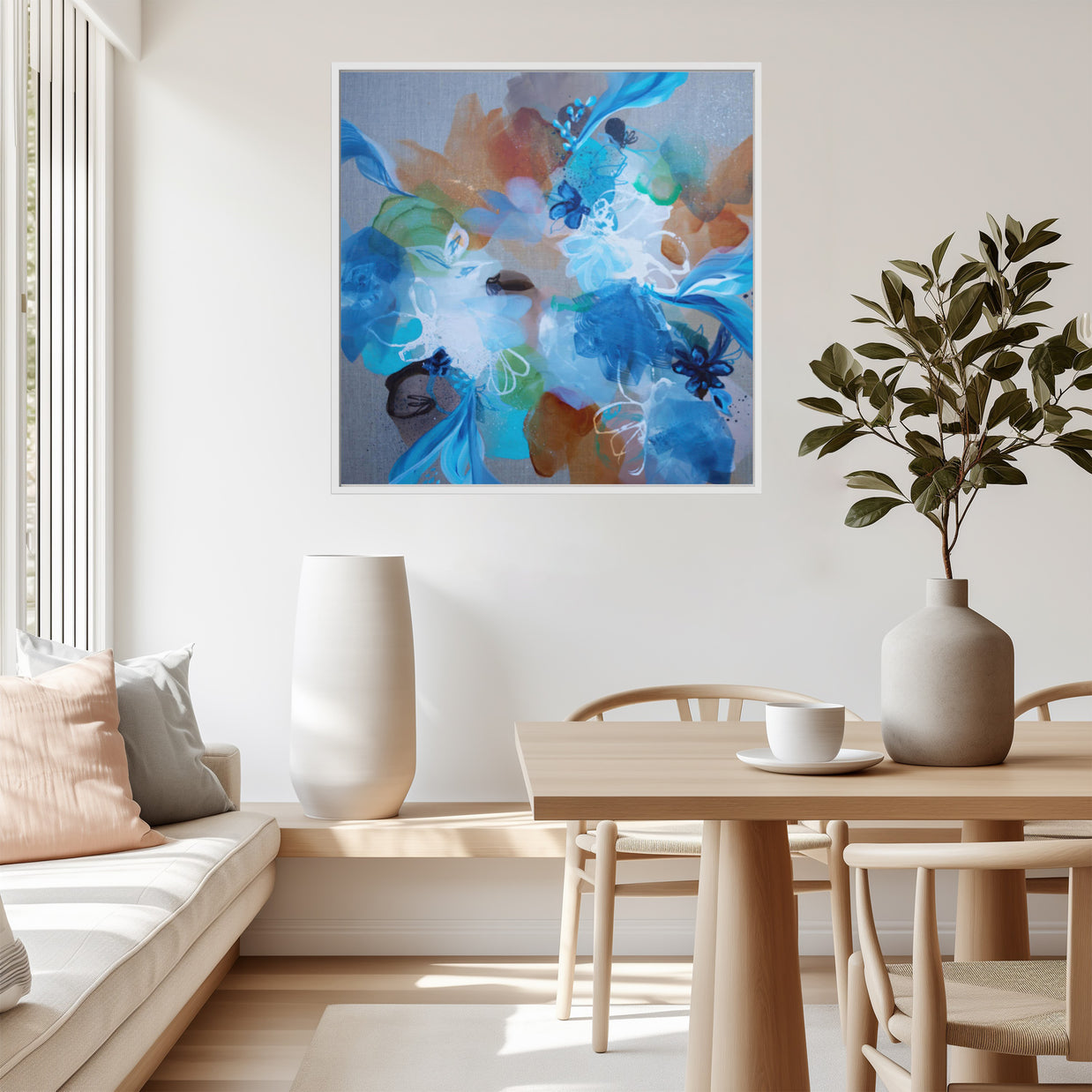 Modern living room with abstract artwork, table, and plant