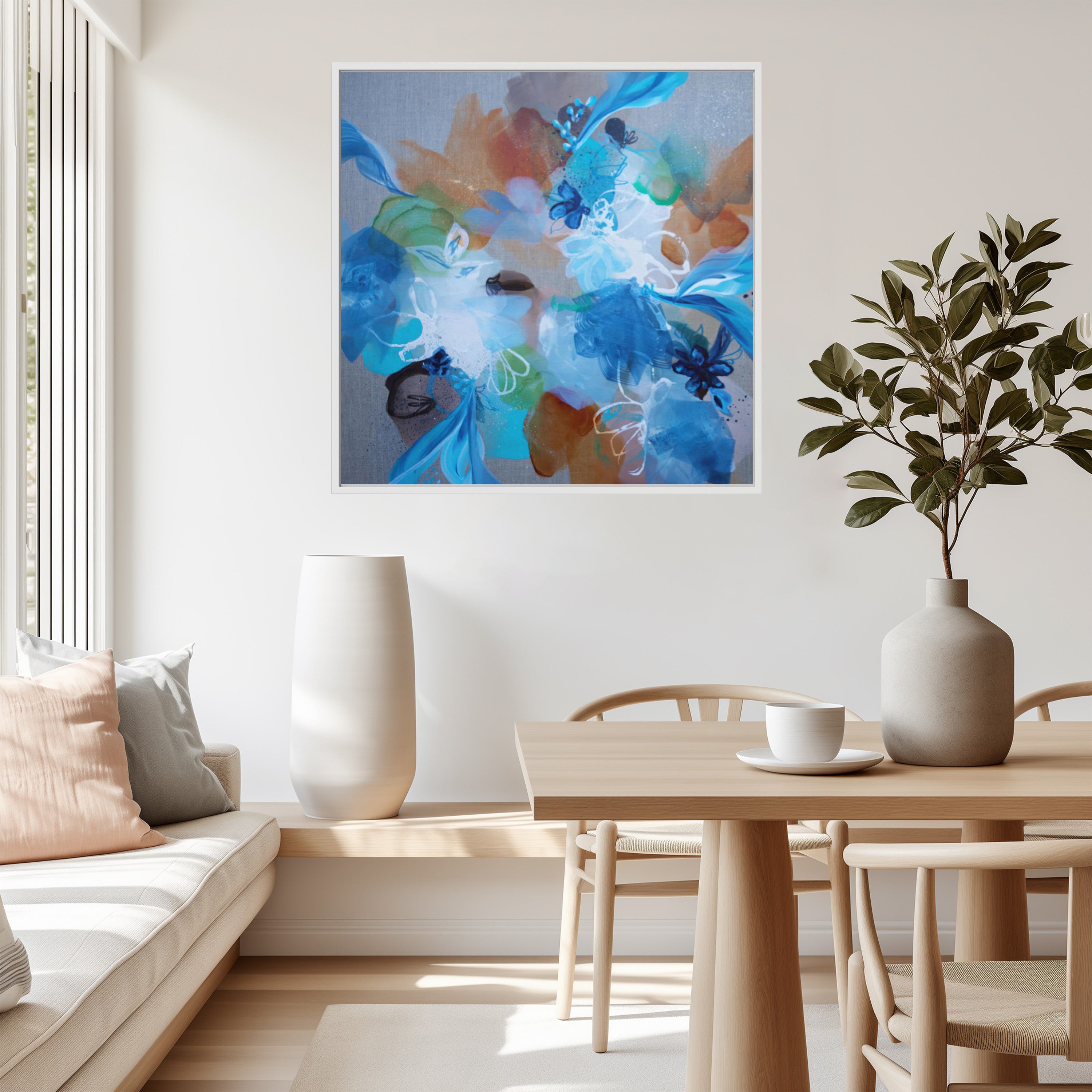 Modern living room with abstract artwork, table, and plant