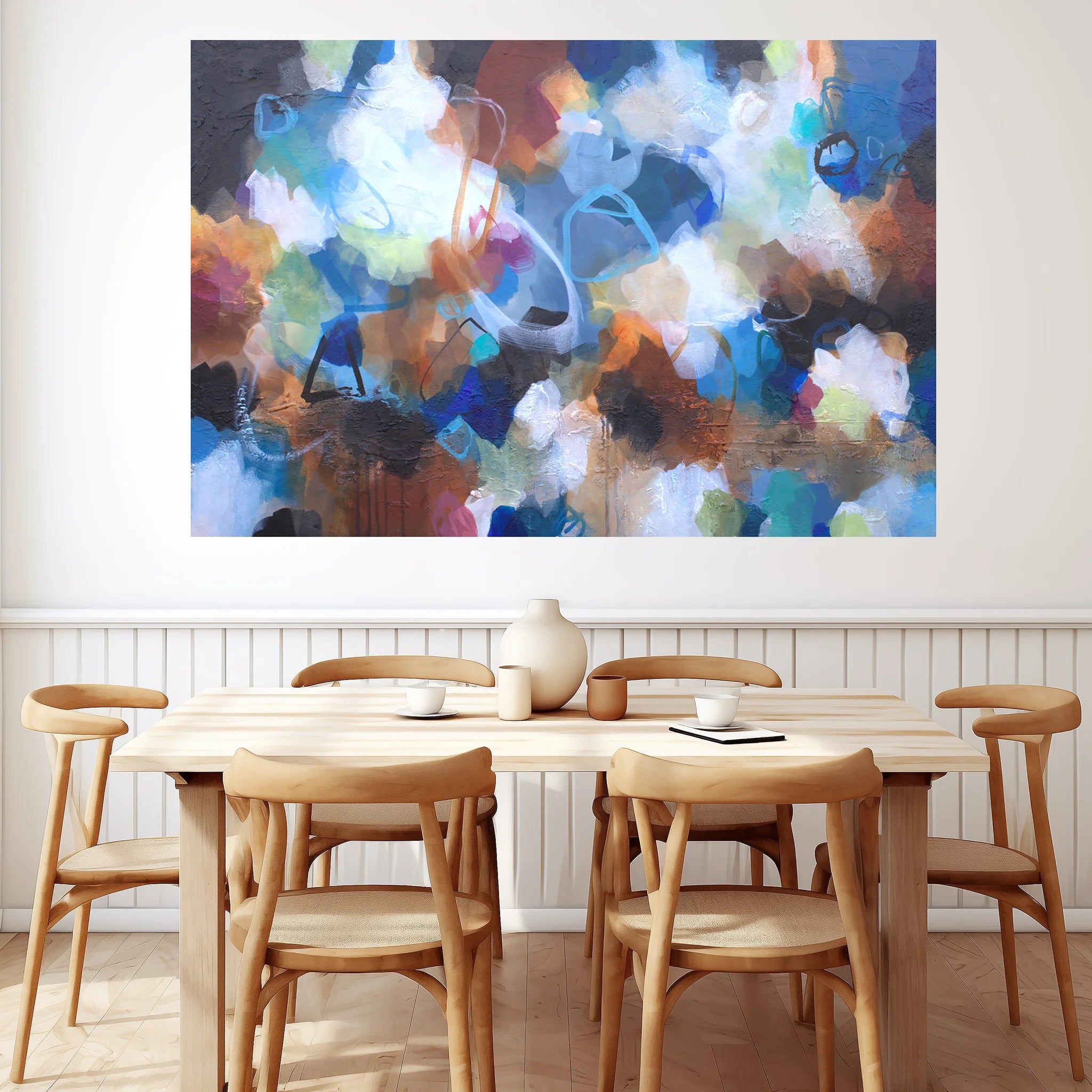 Dining room with wooden table and chairs, colorful abstract painting on the wall.