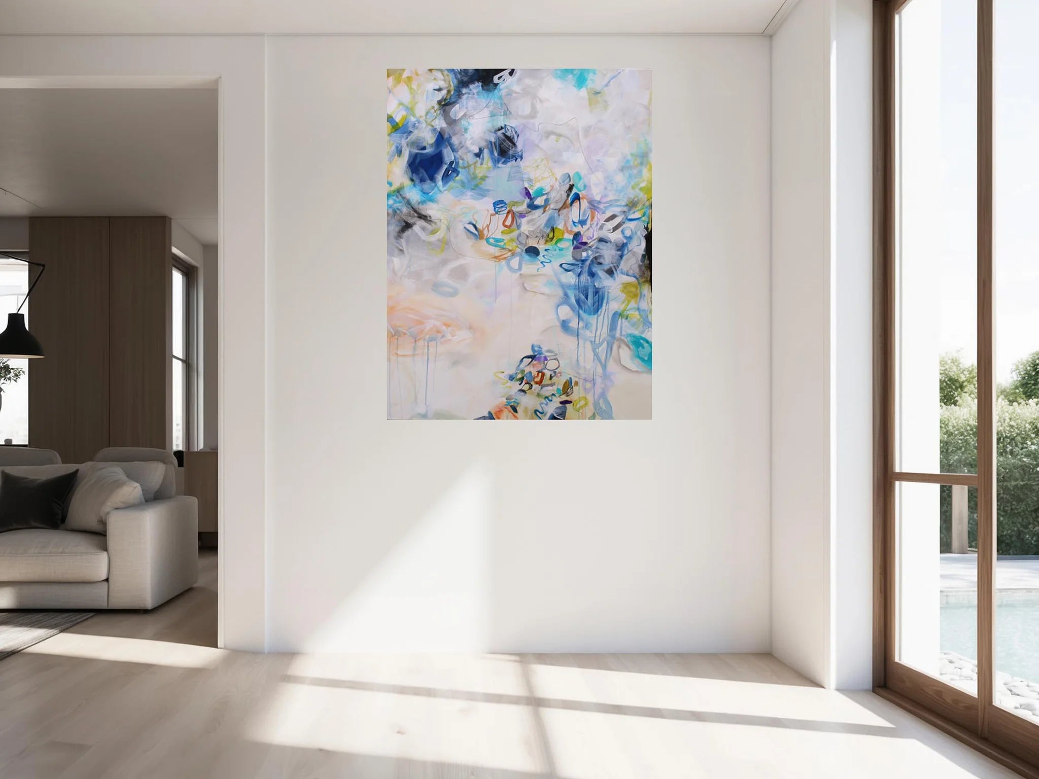 Colourful blue, white, yellow and green abstract painting hanging on wall