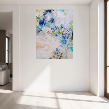 Colourful blue, white, yellow and green abstract painting hanging on wall