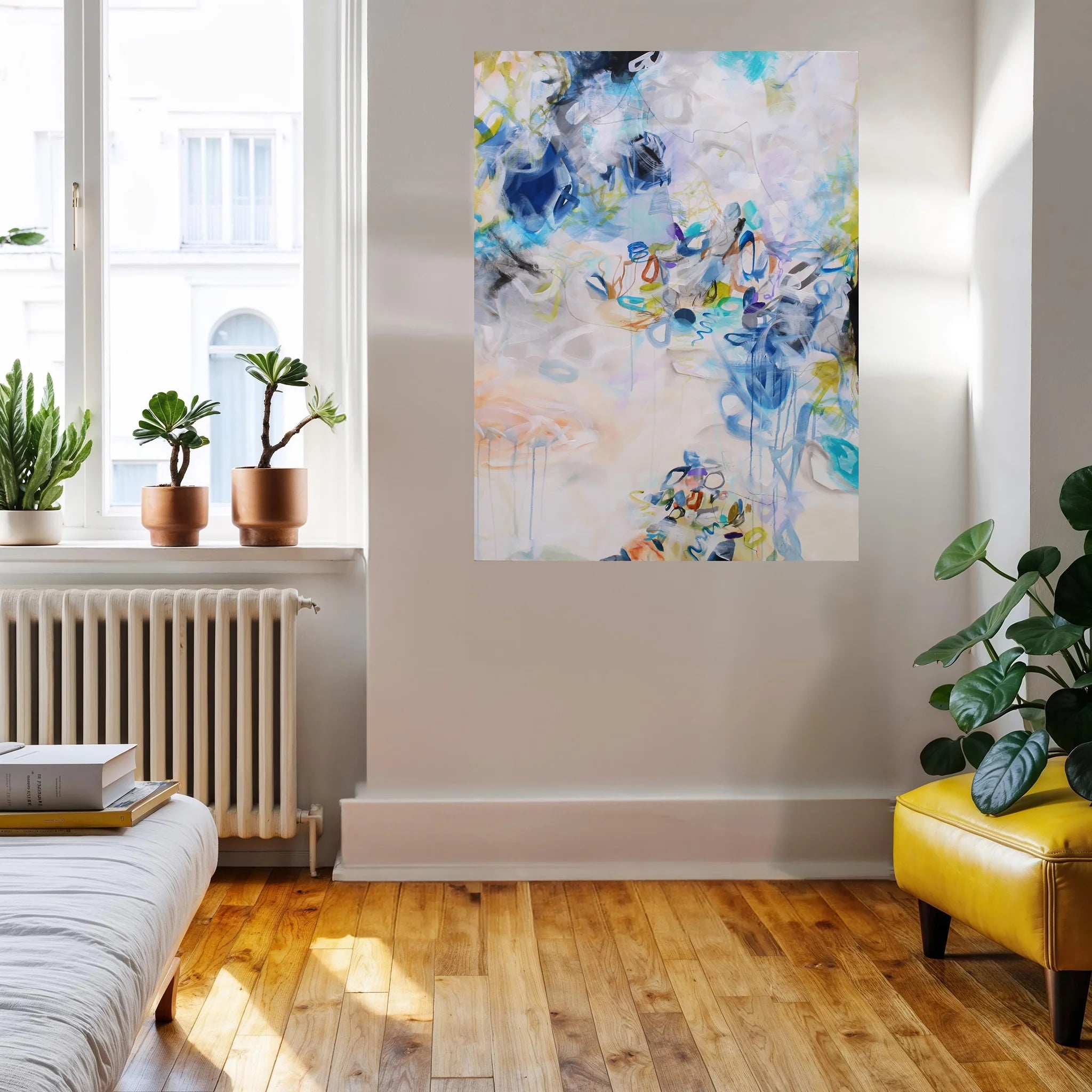 Colourful blue, white, yellow and green abstract painting hanging on wall above sofa