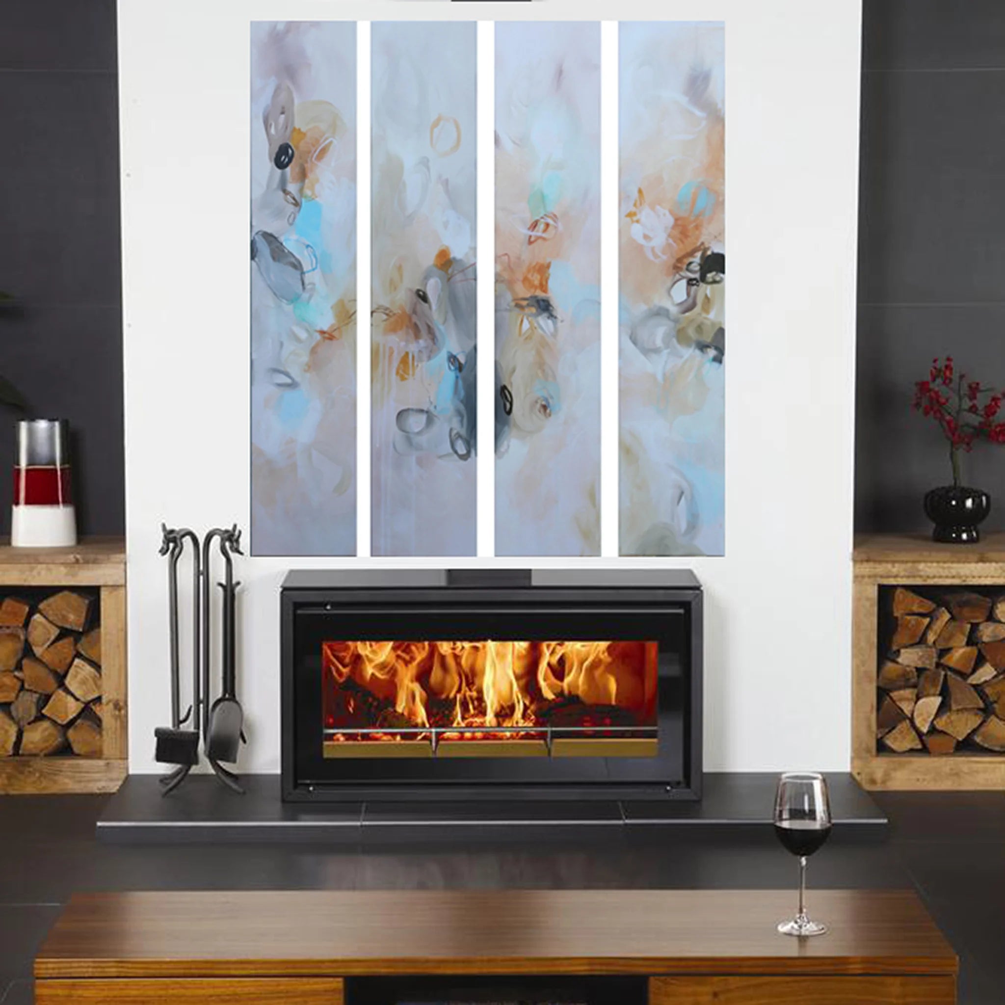 Modern fireplace with wooden logs on either side, featuring abstract wall art above.
