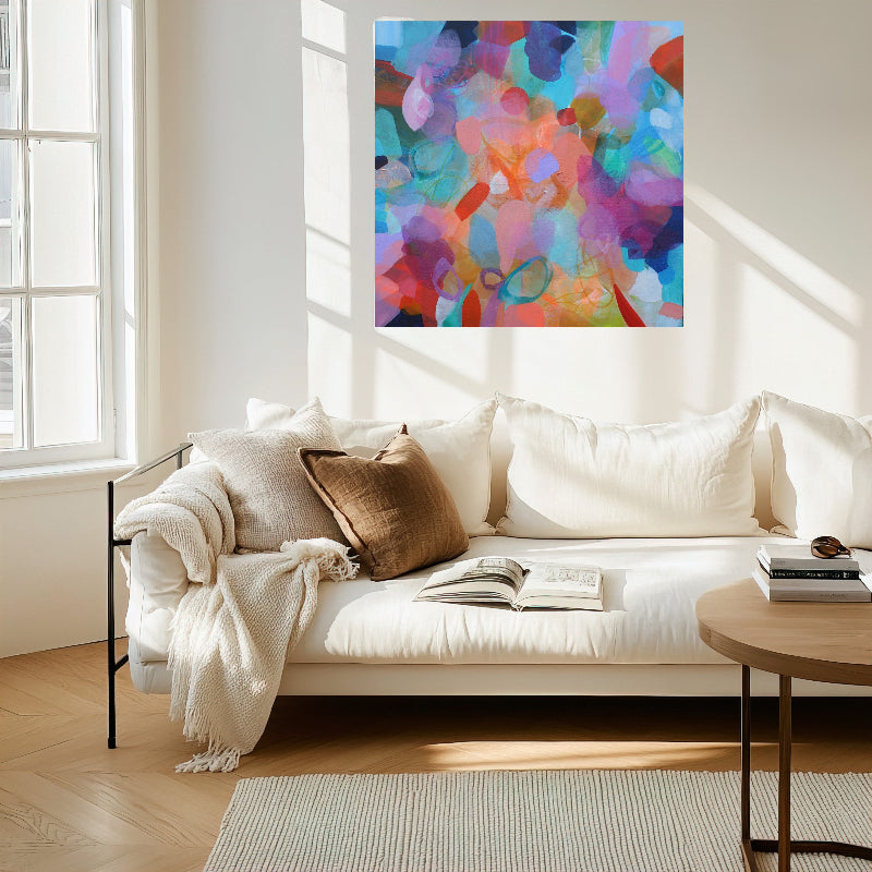 Living room with a colorful abstract painting on the wall above a white sofa.