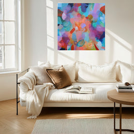 Living room with a colorful abstract painting on the wall above a white sofa.