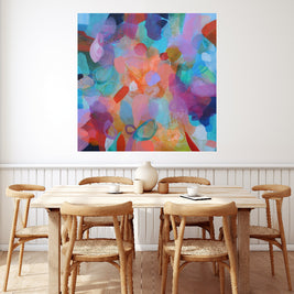 Dining room with a wooden table and chairs, colorful abstract painting on the wall.