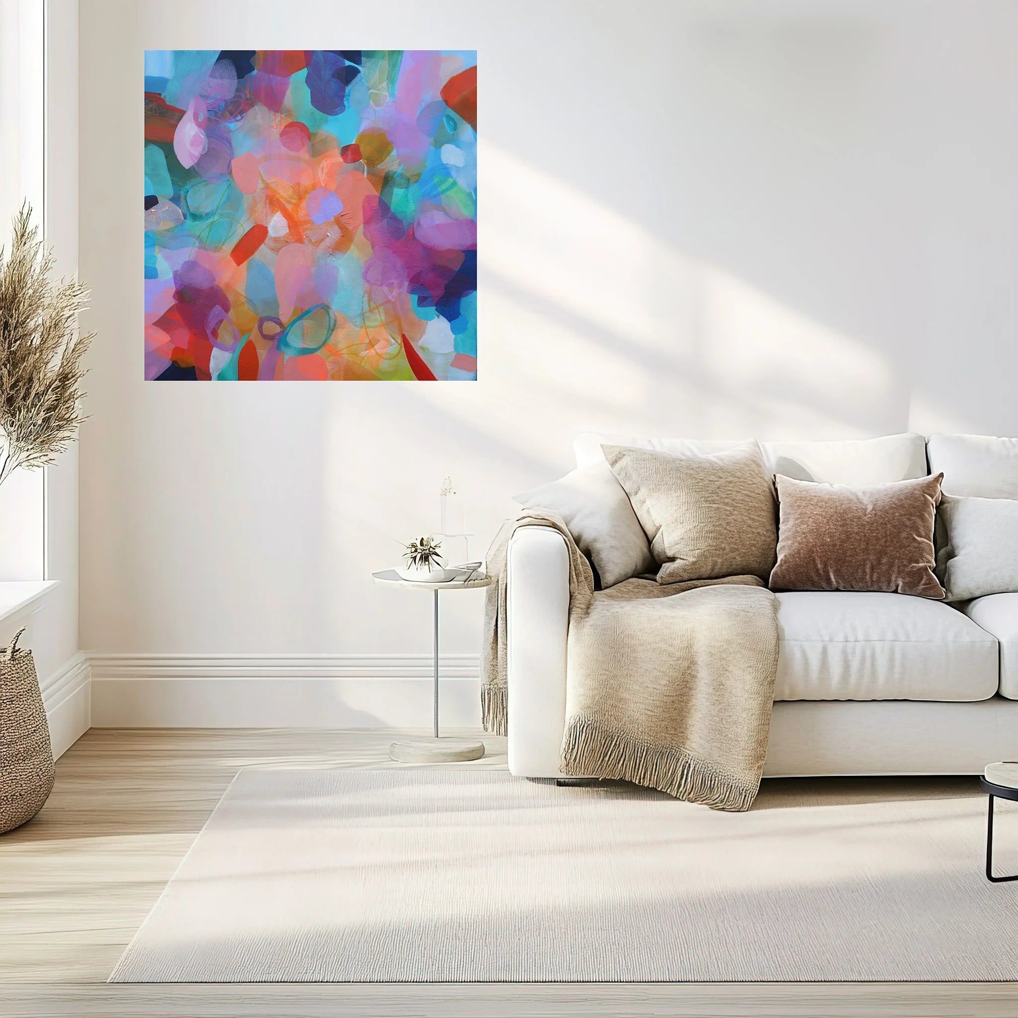 Modern living room with a colorful abstract painting on the wall above a white sofa.