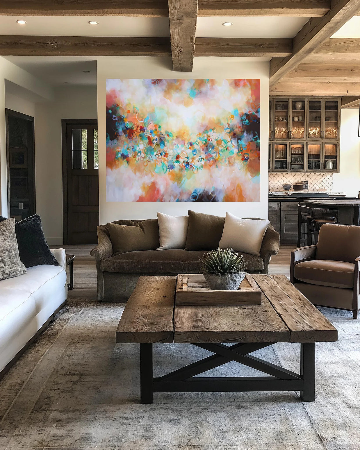 Modern living room with a colorful abstract painting, brown sofa, and wooden coffee table.