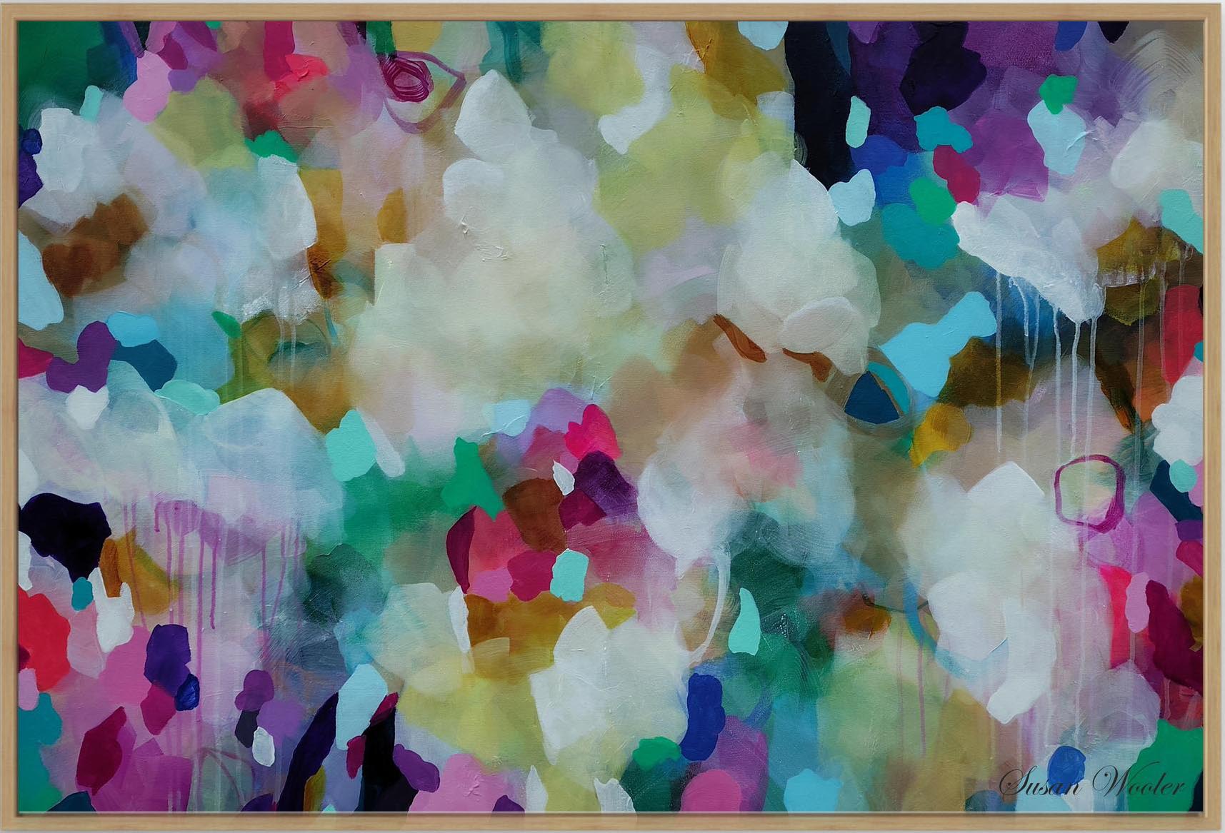 An abstract framed painting with a colorful watercolor-like composition featuring white, pink, purple, green, blue, and yellow tones, enclosed in a light wood frame.