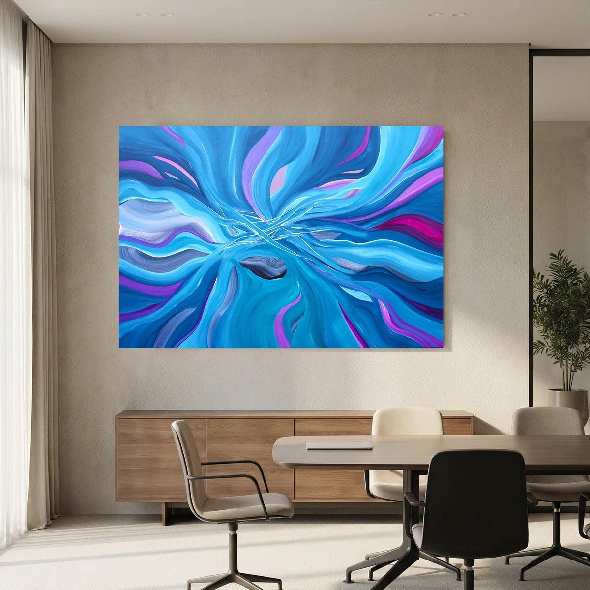 A large abstract wall art print with swirling blue, purple, and cyan brushstrokes hangs on a beige wall above a modern dining table and chairs in a bright office or showroom.