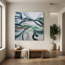 Abstract canvas wall art with flowing blue, green, gray, and white wave-like lines, displayed above a wooden bench in a modern beige-toned interior with a potted tree nearby.