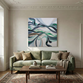 An abstract canvas painting with flowing blue, green, and white swirls hangs on a beige wall above a sage green sofa in a styled living room.
