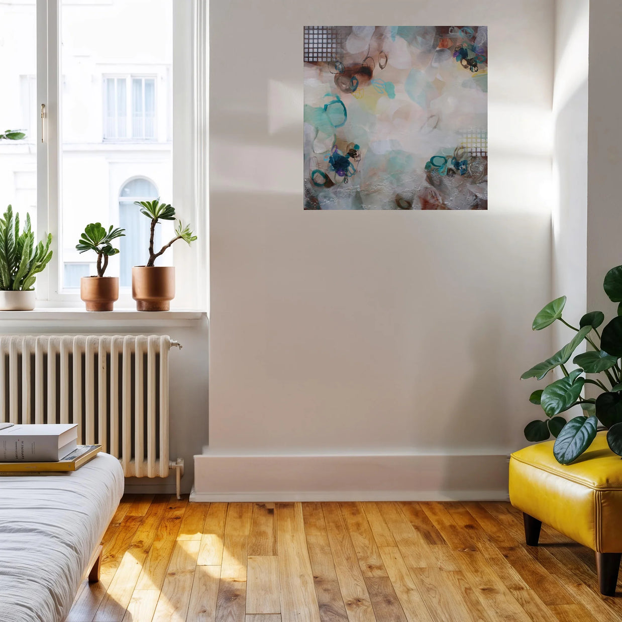 Modern living room with a yellow ottoman, plants, and abstract art on the wall.