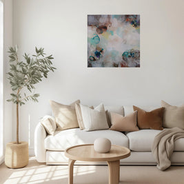 Modern living room with a white sofa, abstract painting, and decorative items.