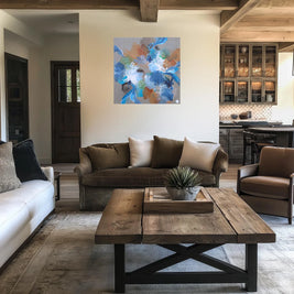 Modern living room with brown sofa, white rug, and abstract painting on wall.