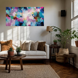 Living room with a colorful abstract painting on the wall, white sofa, and decorative elements.