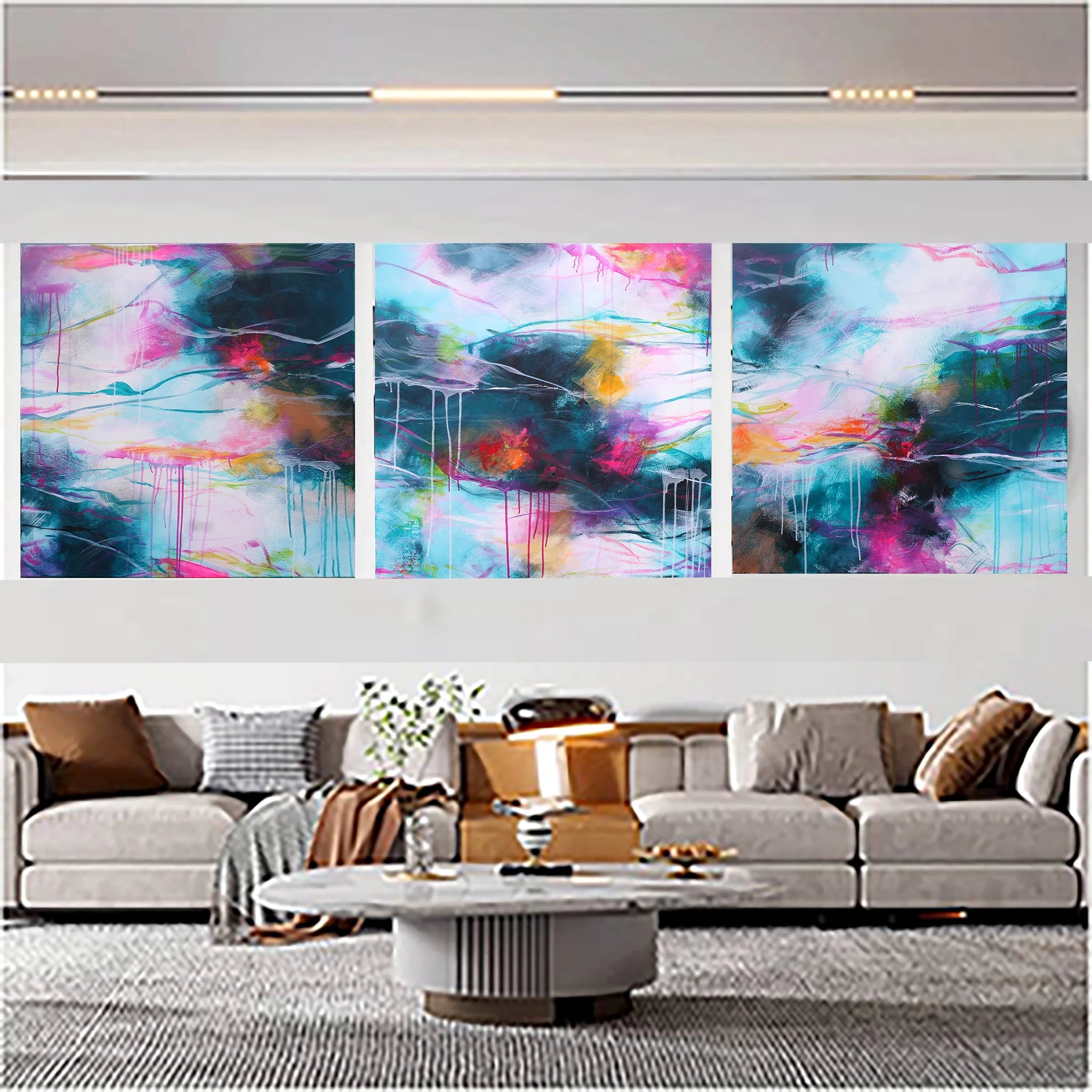 Abstract art triptych on a wall above a sofa in a living room
