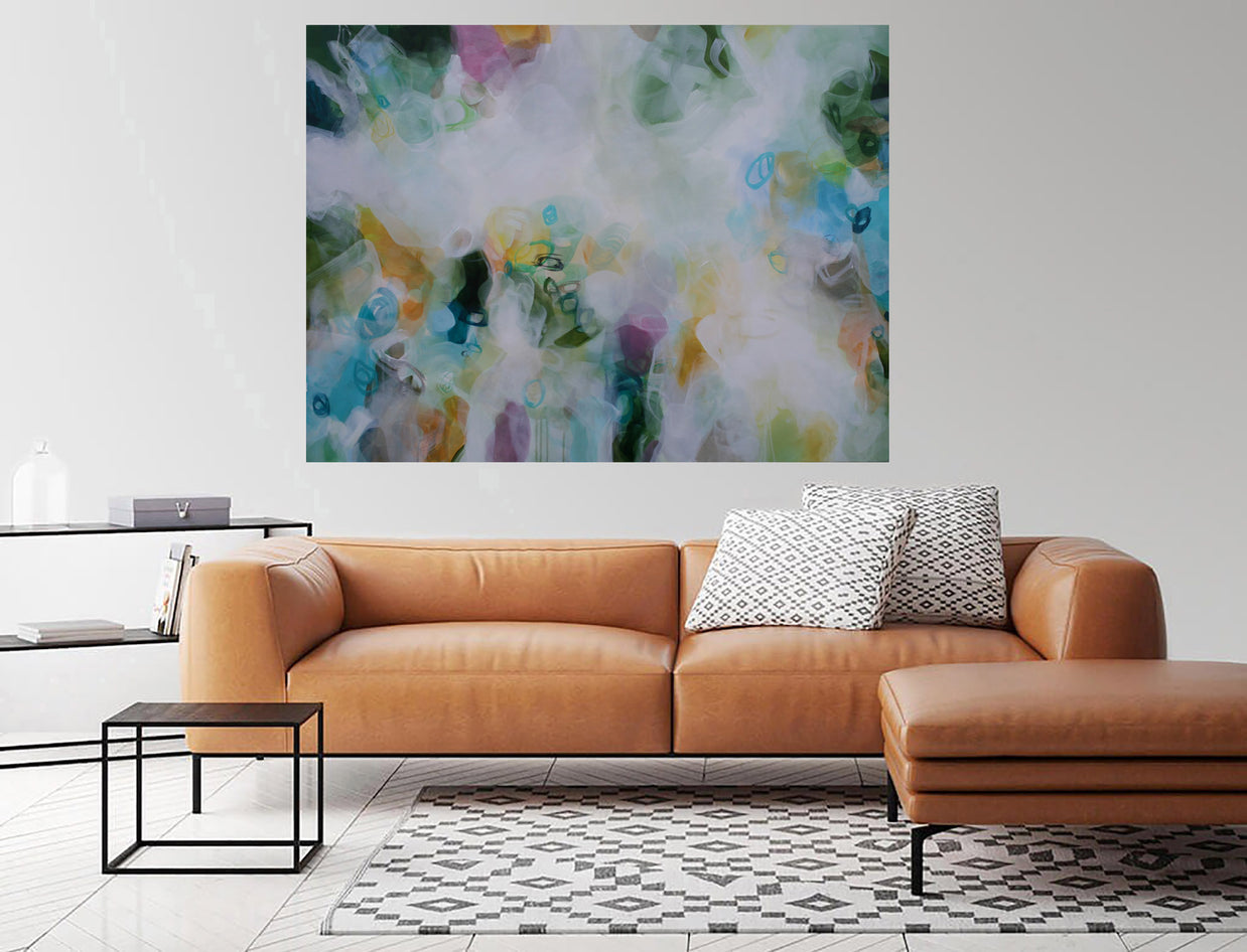 Modern living room with a brown leather sofa, abstract painting, and side table.