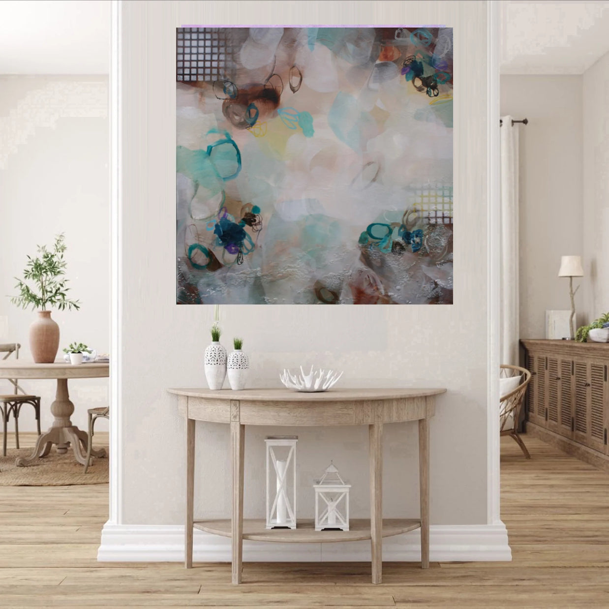 Abstract painting on a wall above a wooden console table in a living room.