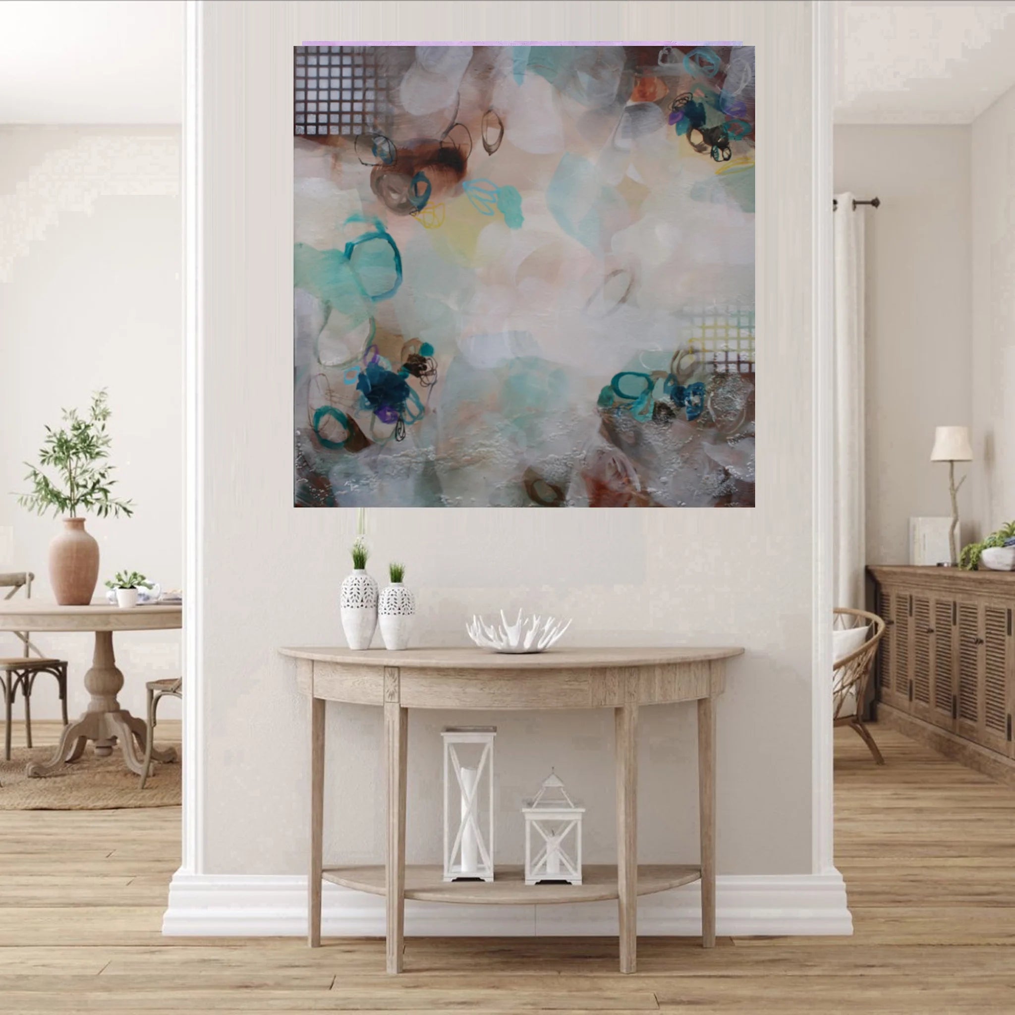 Abstract painting on a wall above a wooden console table in a living room.