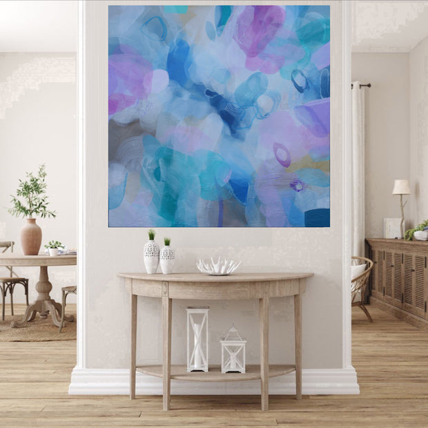 Colorful abstract painting on a wall in a living room setting.