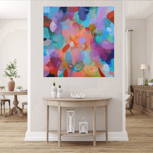 Colorful abstract painting on a wall in a living room setting.