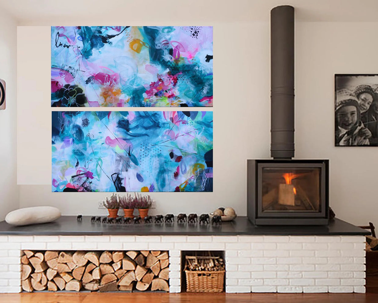 Modern living room with a fireplace, abstract wall art, and decorative items.