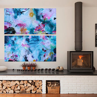 Modern living room with a fireplace, abstract wall art, and decorative items.