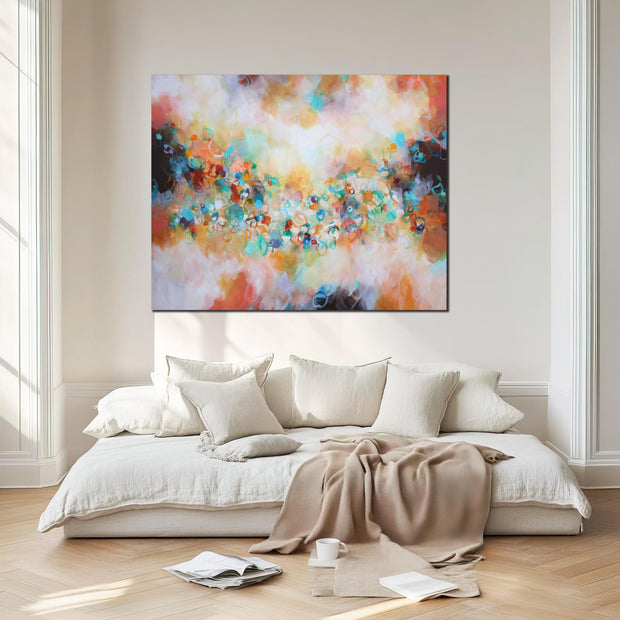 Colorful abstract painting above a bed in a bedroom