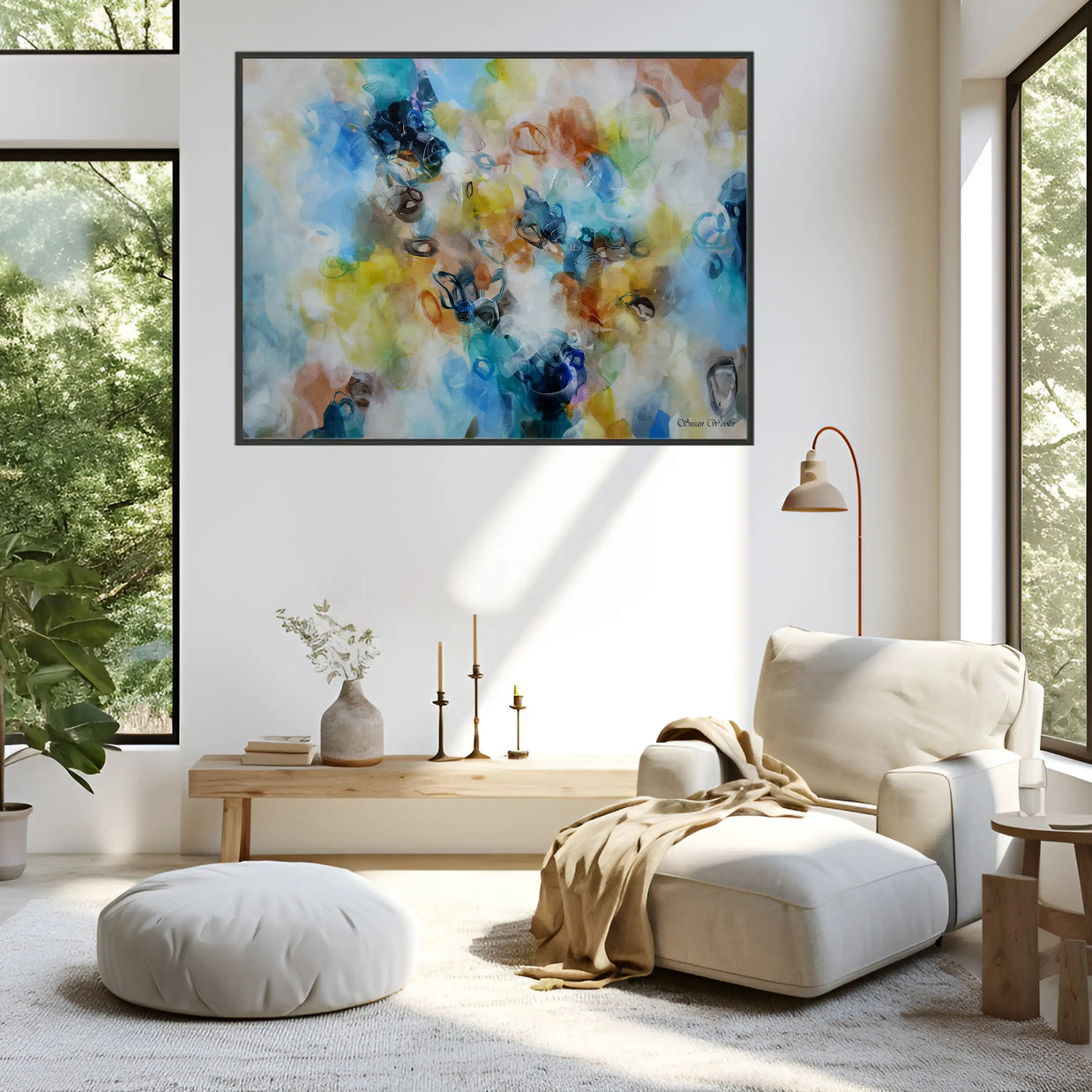 Modern living room with a colorful abstract painting on the wall, white armchair, and wooden coffee table.