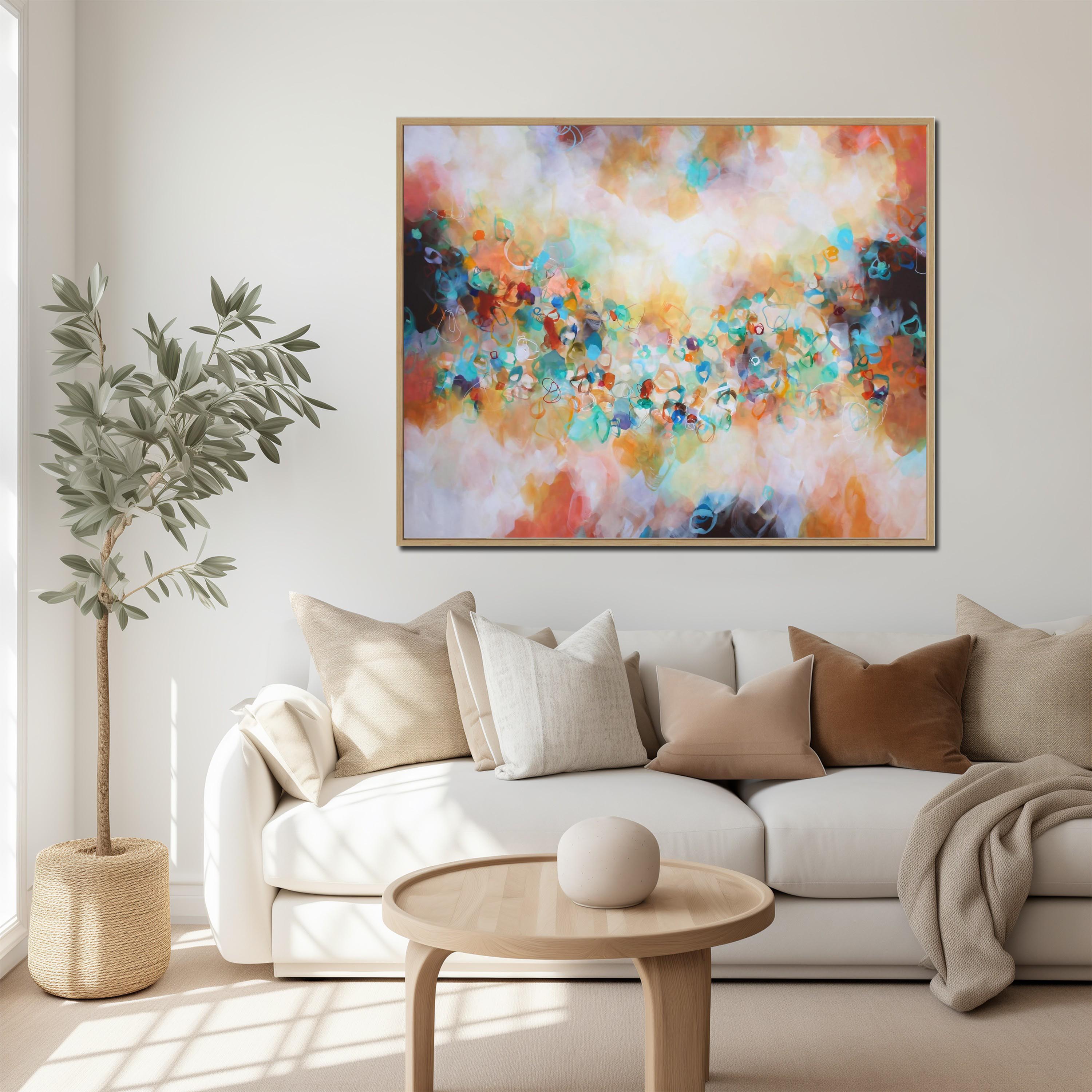 Modern living room with a colorful abstract painting on the wall, white sofa, and wooden coffee table.